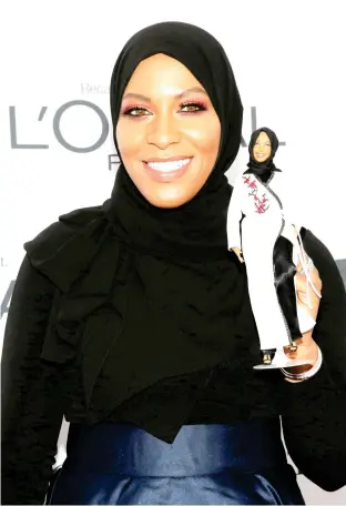  ??  ?? Olympic fencer Ibtihaj Muhammad holds a Barbie doll made in her likeness as she attends the 2017 Glamour Women of the Year Awards in Brooklyn, New York. (Reuters)