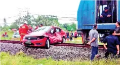  ??  ?? The car and train at the scene of the accident at Jalan Petagas, near the Kota Kinabalu Internatio­nal Airport yesterday.
