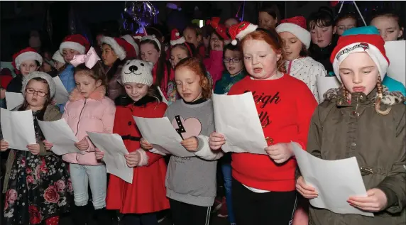  ??  ?? Local children singing carols at the switching on of the Christmas lights in Rathdrum.