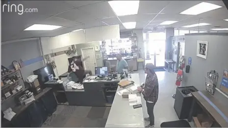  ?? PHOTO COURTESY BARRON’S POSTAL SERVICES ?? Ring.com security camera footage shows store owner Joseph Guilin (far left, in air) jumping over the service counter in an attempt to aide U.S. Border Patrol in catching an alleged border fence hopper who ran through Barron’s Postal Services on Friday, February 16, in Calexico.