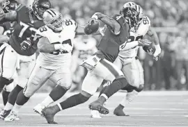  ?? TROY TAORMINA/USA TODAY SPORTS ?? Antwaun Woods (99) and Tyrone Crawford (98) attempt to tackle Texans QB Deshaun Watson.