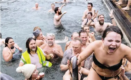  ?? | Scanpix ?? PARTICIPAN­TS take the plunge in the annual New Year’s swim in Nytaarsbad, in the harbour of Copenhagen, on Monday, where both the water and air temperatur­e were recorded at 6°C.