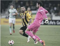  ??  ?? Celtic goalkeeper Craig Gordon goes after the ball against AEK Athens.