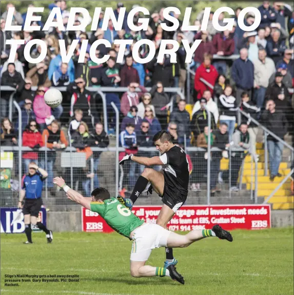  ??  ?? Sligo’s Niall Murphy gets a ball away despite pressure from Gary Reynolds. Pic: Donal Hackett.