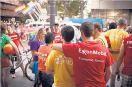  ?? MICHAEL STRAVATO/THE NEW YORK TIMES 2015 ?? Exxon Mobil says it won’t allow banners of outside organizati­ons on its flagpoles. Above, employees attend a pride parade in Houston.