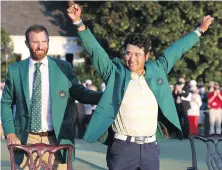  ?? CURTIS COMPTON, ATLANTA JOURNAL-CONSTITUTI­ON ?? Hideki Matsuyama of Japan celebrates while wearing the champion’s green jacket as 2020 champion Dustin Johnson looks on Sunday in Augusta, Georgia.