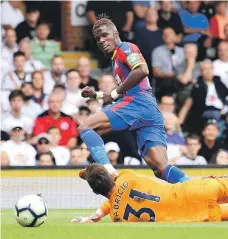  ??  ?? Crystal Palace attacker Wilfried Zaha scores his team’s second goal against Fulham at Craven Cottage yesterday