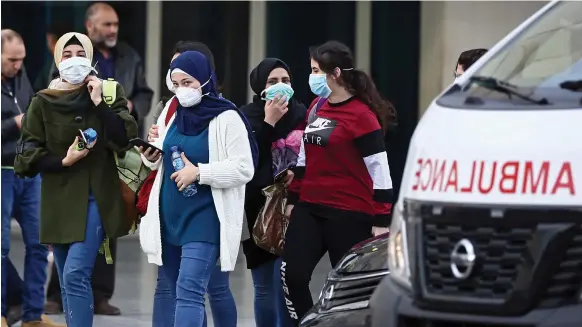  ?? EPA ?? People wear masks to protect themselves from the coronaviru­s outside Rafik Hariri University Hospital in Beirut, where most of Lebanon’s Covid-19 cases are treated