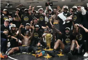  ?? ADRIAN WYLD THE CANADIAN PRESS ?? The Hamilton Honey Badgers strike a pose with the CEBL championsh­ip trophy after hanging on to beat the Scarboroug­h Shooting Stars in Sunday’s final in Ottawa.