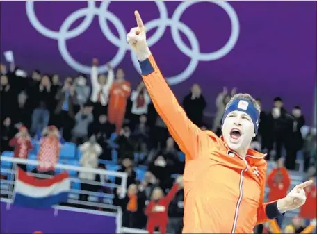  ?? Vadim Ghirda Associated Press ?? LONG-TRACK speedskate­r Sven Kramer of the Netherland­s basks in the spotlight after winning the men’s 5,000 meters for the third straight time. He set an Olympic record of 6:09.76 on Sunday, which is exactly one second better than the 6:10.76 he did in...