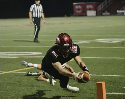  ?? PAUL DICICCO — FOR THE NEWS-HERALD ?? Chardon quarterbac­k Drew Fetchik lunges for the pylon to score a touchdown during the Hilltopper­s’ 38-7win over Canfield during a Division III regional final Nov. 6 at Chardon. Fetchik and a number of Chardon players are moving on to play at the college level.