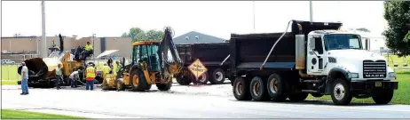  ?? Photo by Randy Moll ?? A project to repave SWEPCO Road in Gentry was underway yet Monday, causing temporary road closings. Workers were busy July 28 at the corner of SWEPCO Road and Pioneer Lane.