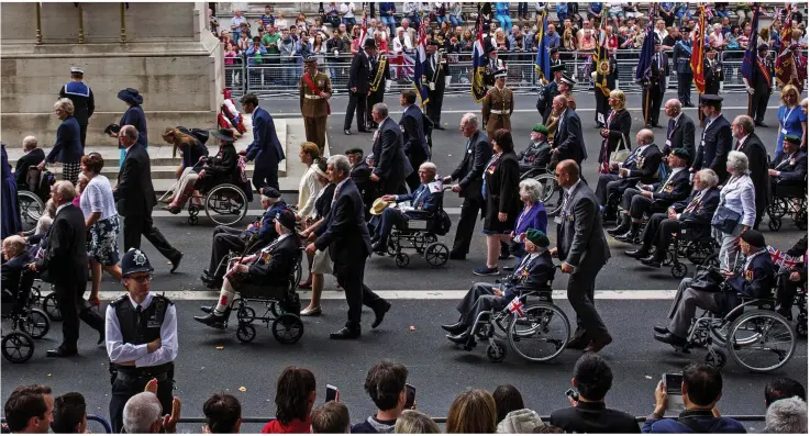  ??  ?? Heroes: Veterans march past the Cenotaph on Whitehall on Saturday as events in London marked the 0th anniversar­y of victory over Japan in the Second World War