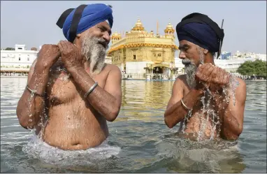  ?? ?? Sikh devotees in the pool at the Golden Temple to mark the birth anniversar­y of the fourth Sikh Guru Ramdas in Amritsar, India