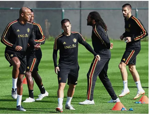  ?? — AFP ?? Hard at work: Belgium’s Eden Hazard (centre) warming up with teammates at the Red Devils Stadium in Tubize yesterday.