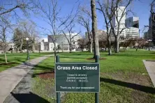  ?? ?? A sign saying “Grass Area Closed” is pictured at Civic Center park.