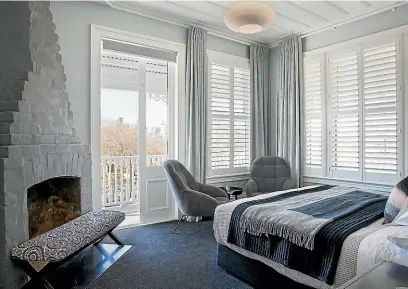  ?? TESSA CHRISP ?? In the same house, shutters in the bedroom are teamed with a roller blind over the door, and floor-toceiling curtains that help to soften the room, visually.