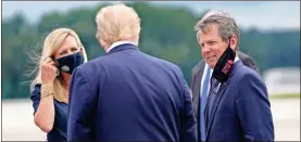  ?? Ap-evan Vucci, File ?? President Donald Trump greets Georgia Gov. Brian Kemp and his wife, Marty, as he arrives at Dobbins Air Reserve Base for a campaign event on Sept. 25, 2020, in Atlanta.