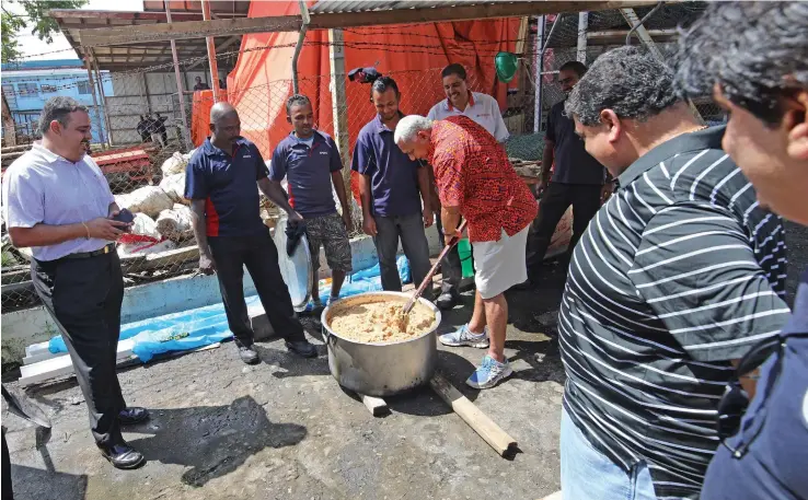  ?? Photo: Office of the Attorney-General ?? Prime Minister Voreqe Bainimaram­a checking the food cooked for distributi­on in flood-hit Ba earlier this week.