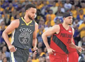  ??  ?? Warriors guard Stephen Curry, left, and Trail Blazers guard Seth Curry are seen Thursday during Game 2 of the Western Conference. KYLE TERADA/USA TODAY SPORTS