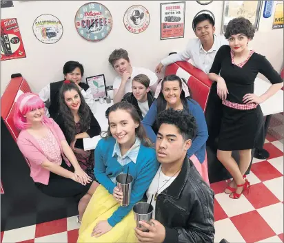  ??  ?? EXCITED: Front, Jessica Handisides, as Sandy, and Taliai Ioelu, as Danny, get into character for Horsham St Brigid’s College’s production of Grease at Café Red Cherry with fellow cast members.
Picture: PAUL CARRACHER