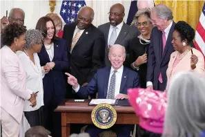  ?? AP Photo/Evan Vucci ?? President Joe Biden points to Opal Lee after signing the Juneteenth National Independen­ce Day Act on Thursday in the East Room of the White House in Washington. From left are Rep. Barbara Lee, D-Calif, Rep. Danny Davis, D-Ill., Opal Lee, Sen. Tina Smith, D-Minn., Vice President Kamala Harris, House Majority Whip James Clyburn of S.C., Sen. Raphael Warnock, D-Ga., Sen. John Cornyn, R-Texas, obscured, Rep. Joyce Beatty, D-Ohio, Sen. Ed Markey, D-Mass., and Rep. Sheila Jackson Lee, D-Texas.
