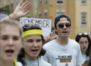  ?? STEVEN SENNE — THE ASSOCIATED PRESS FILE ?? David Hogg, 18, center right, a survivor of the school shooting at Marjory Stoneman Douglas High School, in Parkland, Fla., walks in a planned 50-mile march in Worcester, Mass. Hogg, became the most prominent spokesman for March for Our Lives, a group he and other Stoneman Douglas students founded that is pushing for stronger gun laws.