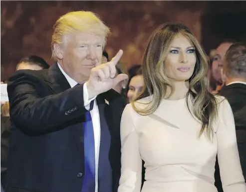  ?? JULIE JACOBSON / THE ASSOCIATED PRESS ?? A triumphant Republican presidenti­al candidate Donald Trump, left, with his wife Melania in New York Tuesday night.