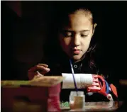  ?? NATACHA PISARENKO / AP ?? Kaori Misue attends an art class earlier this month in Buenos Aires, Argentina. Misue, who was born without fingers, can now flex her wrist muscles to bend the plastic fingers and she can work with tape and stickers.