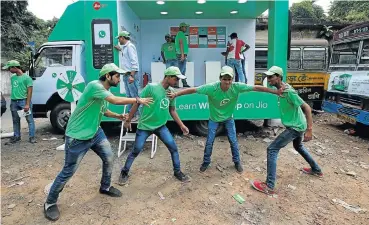  ?? Picture: Reuters/Rupak De Chowdhuri ?? WhatsApp-Reliance Jio representa­tives perform in a street play during a drive by the two companies to educate users near Kolkata, India, this week.