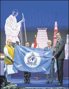  ?? PTI ?? Union home minister Amit Shah hands over the Interpol flag to Director of CIS of Austria, Andreas Holzer, during the 90th General Assembly of Interpol, in New Delhi on Friday.