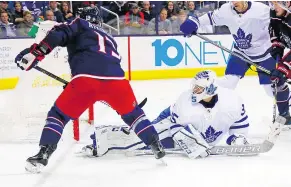  ?? — GETTY IMAGES ?? Maple Leafs goalie Curtis McElhinney stops a shot from forward Cam Atkinson Wednesday at Nationwide Arena in Columbus, Ohio, during the Blue Jackets’ 4-2 victory over Toronto.