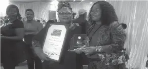  ??  ?? Mrs Beatrice Marumahoko (left) poses with a certifific­ate and trophy she won at the Women in Enterprise Awards held in Harare