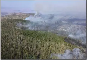  ?? (AP/U.S. Forest Service/Jerod Delay) ?? Smoke from a wildfire is seen Monday in part of Medicine Bow National Forest where the fire has been burning since Thursday, prompting an evacuation order for a 300-square-mile portion of the forest in southeaste­rn Wyoming.