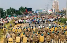  ?? — PTI ?? Police personnel try to stop farmers demanding a fair price for agricultur­e produce, pension and prestige at Pahala, Bhubaneswa­r, on Monday.