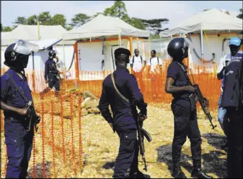  ?? Al-Hadji Kudra Maliro The Associated Press ?? Police officers stand guard Friday at a newly establishe­d Ebola response center in Beni, Congo. Vaccinatio­ns began Wednesday in the current outbreak.