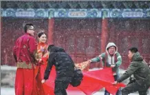  ?? LIU CHANG / FOR CHINA DAILY ?? A photo crew prepares the backdrop for a romantic shoot at the Palace Museum in Beijing on Thursday, Valentine’s Day.