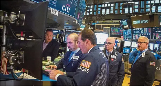  ??  ?? Good returns: A file picture showing traders at of the New York Stock Exchange. Stock-market returns have raced far ahead of those on bonds.