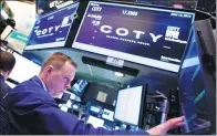  ?? BLOOMBERG ?? Traders work at the Coty Inc booth on the floor of the New York Stock Exchange.