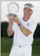  ?? DANIEL SANGJIB MIN — RICHMOND TIMES-DISPATCH VIA AP ?? Bernhard Langer raises his trophy after winning PGA Champions Tour’s Dominion Energy Charity golf Classic at The Country Club of Virginia in Henrico, Va., on Sunday.