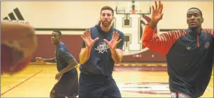  ?? JASON MALLOY/THE GUARDIAN ?? Island Storm players, from left, Franklin Session, Zack Valliere and Du’Vaughn Maxwell look for a pass during Thursday’s practice at Holland College.