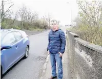  ?? 1603{tyr}road_03 ?? Lucky escape Stuart McPherson stands on the narrow pavement in Biggar Road