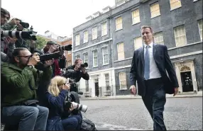  ?? (AP/PA/Stefan Roussea) ?? Jeremy Hunt, shown leaving 10 Downing Street in London on Friday after he was appointed Britain’s treasury chief, says Prime Minister Liz Truss’ new economic policies will “get the country growing.”