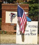  ?? TODD KIRKLAND / AP ?? A protester mans a spot by the Falcons’ facility where Colin Kaepernick was to work out for NFL scouts in November. It was moved.