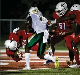  ?? CALLA KESSLER / THE PALM BEACH POST ?? Oxbridge Academy’s Antavious Lane (left) scores a touchdown during a Class 3A playoffff win over Melbourne Central Catholic last week.