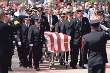  ?? ROB SCHUMACHER/THE REPUBLIC ?? Family and friends follow the casket during the memorial service for Buckeye Fire Chief Bob Costello at Christ’s Church of the Valley on Thursday. Costello died April 8 from cardiac arrest.