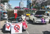  ?? Tribune News Service/getty Images ?? Taxis block a road, pretending to have broken down, during an anticoup protest on Wednesday in Yangon, Myanmar.