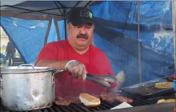  ?? PHOTO ANDY VELEZ ?? Jose Jimenez mans his grill Saturday at the 2019 Carrot Festival and Street Fair in Holtville. Jimenez and his wife, alicia, own DJ Fashion Tacos y Mariscos.