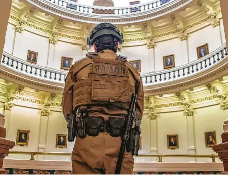  ?? Ricardo B. Brazziell / Associated Press ?? More than 100 Texas troopers, including dozens wearing tactical vests and carrying riot gear, stood guard outside the state Capitol.