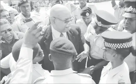  ??  ?? A policeman attempting to arrest MP Juan Edghill (centre) just outside of the police barricade set up near Parliament.